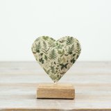 A stylish heart mounted on a wooden base 