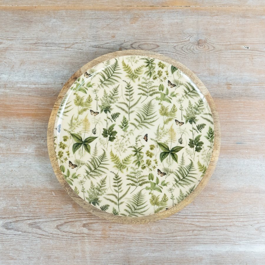 A lovely green serving plate adorned with botanical herb designs.
