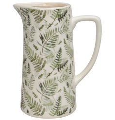 A gorgeous tall jug in white detailed with an intricate fern pattern.