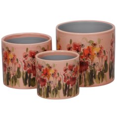 Add charm to your space with this set of 3 rose-colored stoneware planters, 