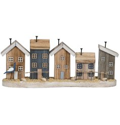 Bring coastal charm home with this wood piece featuring serene blue and white beach houses 