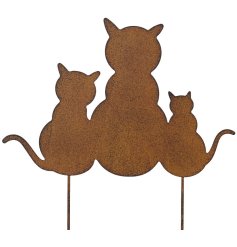 Adorable cat perched on a sturdy iron stake decoration.