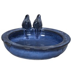 Add charm and color to your garden with this blue glazed earthenware bird bath