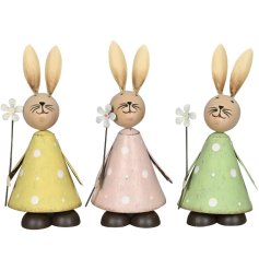 An assortment of 3 charming wooden bunnies, each with a dainty flower and painted polka dot design. 