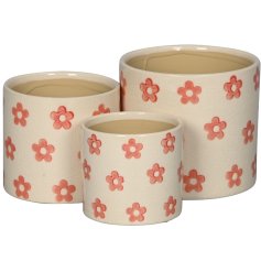 Brighten your home or garden with this vibrant set of 3 durable stoneware flower planters 
