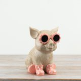 Charming resin pig ornament with natural tones, pink accents, stylish glasses, and colourful wellie