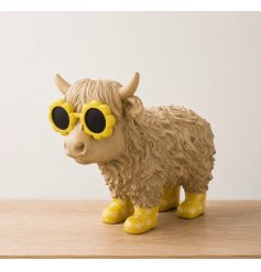 A fun and cheeky highland cow dressed in a pair of yellow wellies and matching sunglasses.