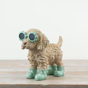 Adorable Cockapoo statue wearing playful flower-shaped glasses.