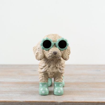 Adorable Cockapoo statue wearing playful flower-shaped spectacles.