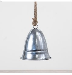 A compact metal hanging bell finished in silver with a sturdy jute hanger.