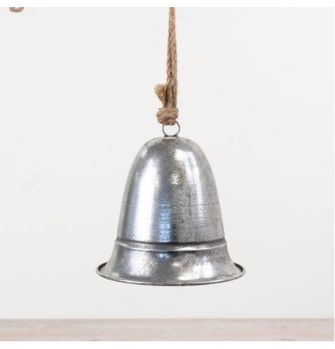 A decorative metal bell finished in brushed silver and suspended from natural jute rope. 