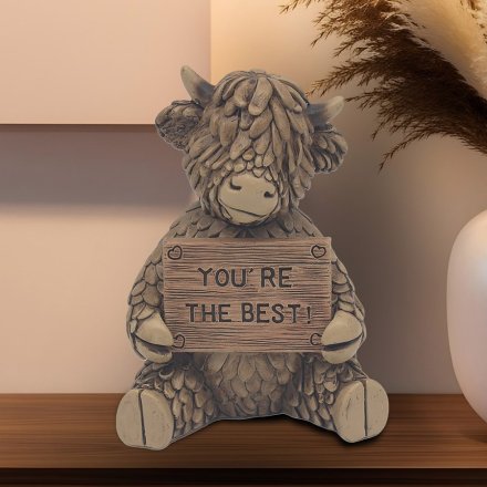 Discover Hughie the Highland Cow, a delightful brown polyresin ornament with a "You Are The Best" sign!