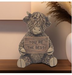 Meet Hughie the Highland Cow! This charming brown polyresin ornament, holding a "You Are The Best" sign,