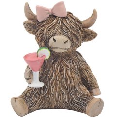 a fun highland cow holding a cocktail glass 
