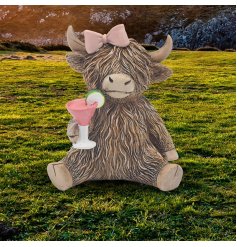 a fun highland cow holding a cocktail glass 