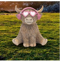a fun highland cow with sunglasses and ear moofs figurine 