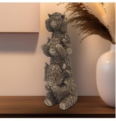 a family of Highland cow all sat on each others shoulders