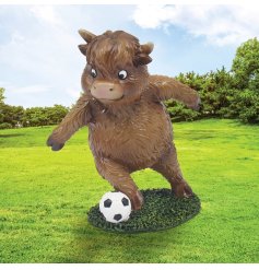 a fun cow figurine playing football