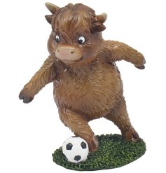 a fun cow figurine playing football