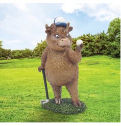a fun highland cow figurine playing golf