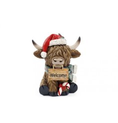 Bring warmth to your holiday décor with this charming Scottish cow decoration.