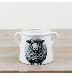Adorable planter pot featuring a cute sheep motif.