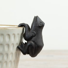 Delightful cast iron frog garden planter hanger with rustic charm.