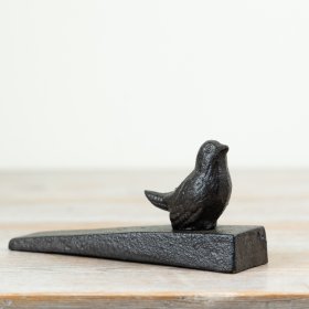 Hold your doors open securely with this charming cast iron bird-shaped door stopper.