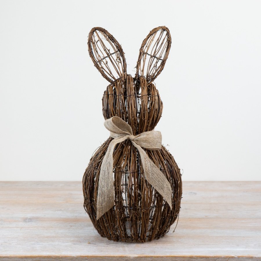 Rattan bunny figurine seated, adorned with an adorable bow.