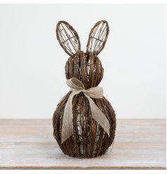 Adorable rattan bunny figurine seated with a charming bow accessory.