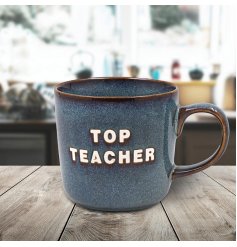 Begin your morning honoring your favorite teacher with the stylish blue grey Top Teacher Mug.