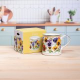 a charming pansies design candle in a mug 