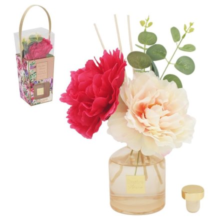 Fragrant reed diffuser with a floral design.