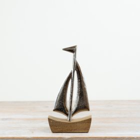 Elegant ship ornament mounted on a base, perfect for decor.