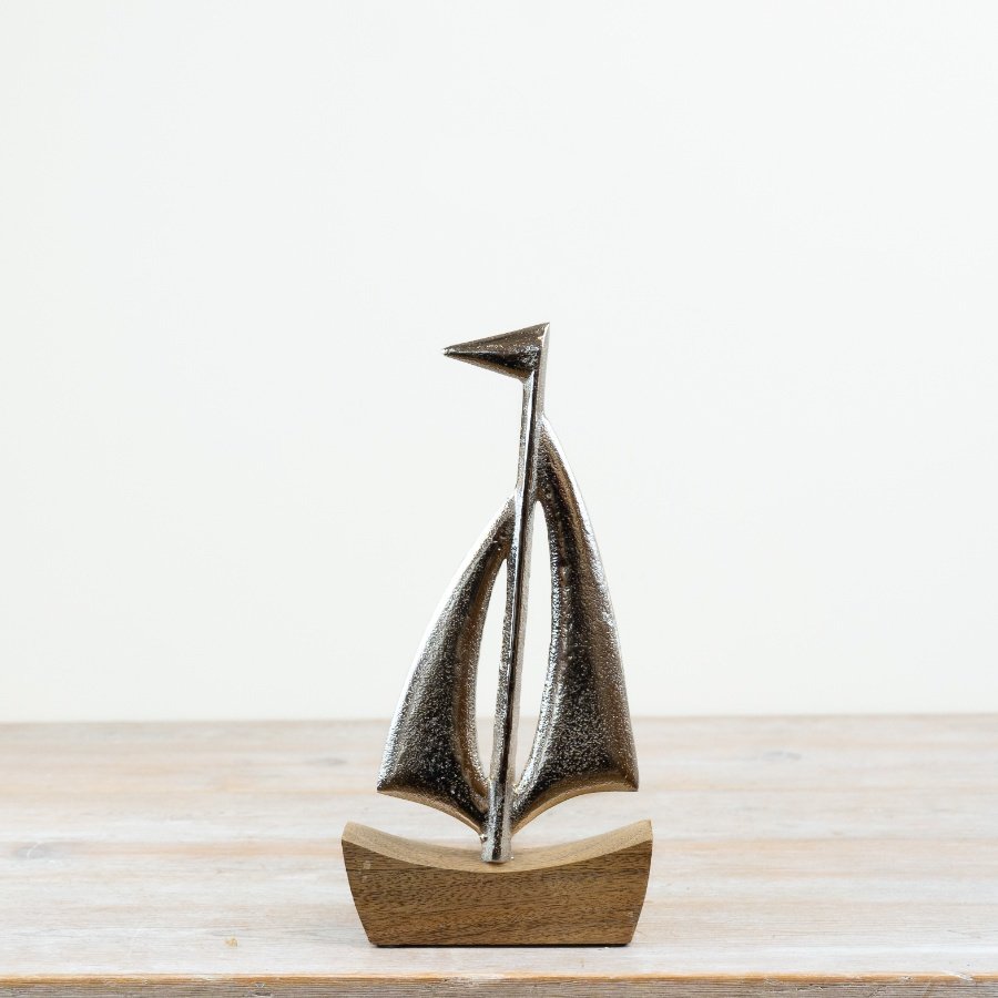 Elegant ship ornament mounted on a base, perfect for decor.