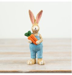 a charming rabbit figurine holding a bunch of carrots 