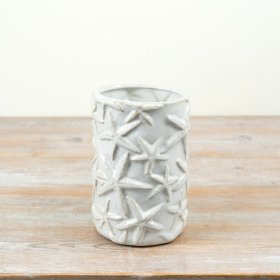 Bring coastal charm home with this cream glazed starfish vase.