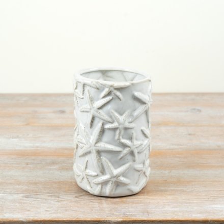 Create a coastal paradise with this cream glazed starfish vase.