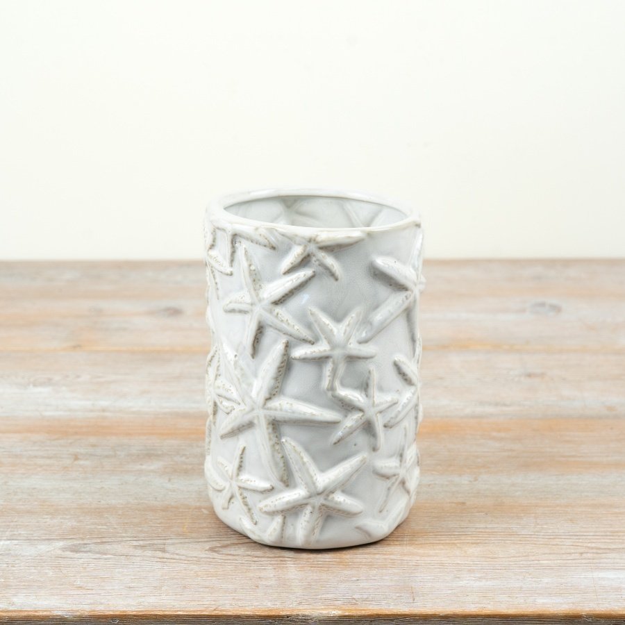 Bring coastal charm home with this cream glazed starfish vase.