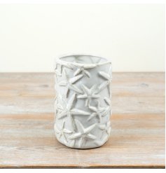 Create a coastal paradise with this cream glazed starfish vase.