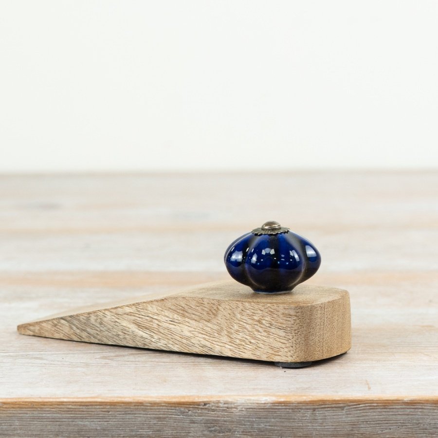Chic door stopper crafted from ceramic and wood for a modern touch.