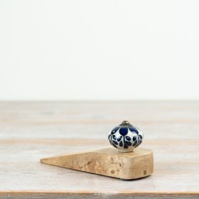 A sleek ceramic stopper designed to hold your door securely in place.