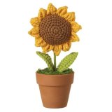 A beautiful knitted sunflower planted in a terracotta pot.