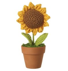 A beautiful knitted sunflower planted in a terracotta pot.