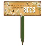 A charming metal stake sign with a humorous quote and a floral illustration.