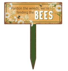 A charming metal stake sign with a humorous quote and a floral illustration.