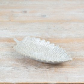 Elegant white porcelain plate shaped like a leaf for a stylish table setting.