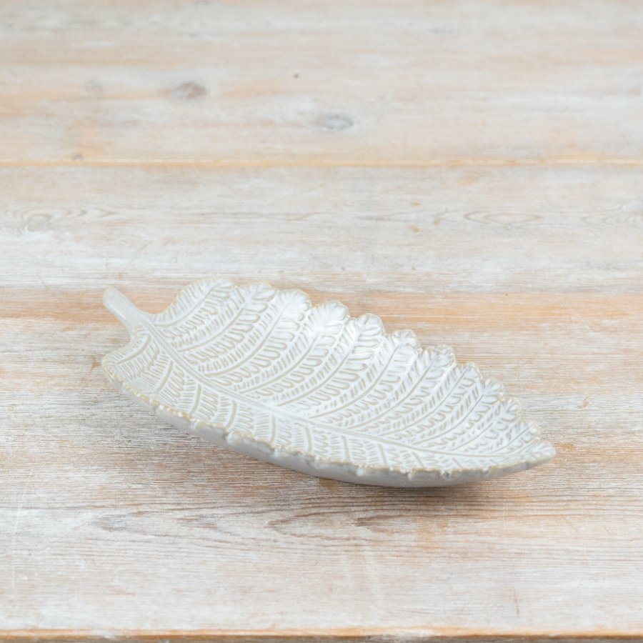 Elegant white porcelain plate shaped like a leaf for a stylish table setting.