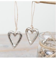 Heart charm with silver finish, suspended on natural jute twine.