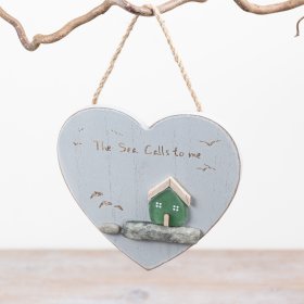 A rustic wall hanging decoration in the shape of a heart featuring dainty pebbles and carved text.